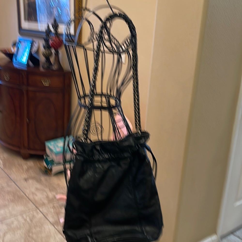 This is a black faux leather bucket bag